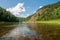 Landscape of Siberia. Kiya River, mountain banks and green forests in the Kemerovo region.