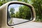 Landscape in the side view mirror of a car