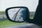 Landscape in the sideview mirror of a car