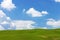 Landscape with sky, clouds, hills and grass