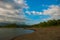 Landscape sky with clouds, volcanic sand on the beach. Pandan, Panay, Philippines.