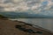 Landscape sky with clouds, volcanic sand on the beach. Pandan, Panay, Philippines.