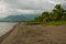 Landscape sky with clouds, volcanic sand on the beach. Pandan, Panay, Philippines.