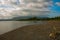 Landscape sky with clouds, volcanic sand on the beach. Pandan, Panay, Philippines.