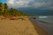 Landscape sky with clouds, volcanic sand on the beach. Pandan, Panay, Philippines.