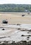 Landscape with small boats on the sand flats at Red Wharf bay, Anglesey, Wales.