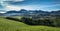 Landscape with smooth rolling hills and green pastures in bright sunlight