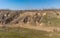 Landscape with soil erosion at early spring season