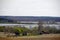 Landscape. Spring. April. View of the village and lake. Fields and meadows. The woods.