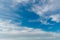 Landscape of stretched clouds of white light against a blue sky