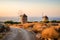 Landscape at sunset, old windmills at golden hour