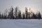 Landscape sunset on the snow frosty river