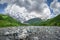 Landscape of svaneti mountains, Georgia. Amazing view of mountain Dzhangi-Tau and glacier Khalde from stones shore of river