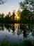 Landscape with swamp lake at sunset, beautiful reflections of calm blurred lake water