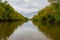 Landscape of Teteriv River, which flows through Ukraine in Europe - photo from boat in  middle of river with overgrown deciduous f