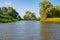 Landscape of Teteriv River, which flows through Ukraine in Europe - photo from boat in  middle of river with overgrown deciduous f