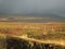 Landscape at Thingvellir, Iceland, around the continental rift, sunlit on the background of dark grey clouds