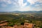 Landscape from tower of Capalbio castle, Tuscany, Italy, with fields, hills, buildings, blue sky and clouds