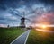 Landscape with traditional dutch windmills and path near the water canals.