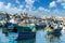 Landscape with traditional Luzzu boat in harbor of Marsaxlokk, Malta