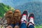 Landscape, travel, tourism. A pair of feet in the shoes against the background of the mountains. Horizontal frame