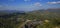 Landscape of trees overlooking beautiful city and mountains