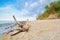 Landscape with trunk on beach. Baltic Sea coast.