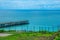 Landscape with turquoise calm sea water, mountain caves and touristic boat