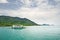 Landscape with turquoise tropical sea, cargo ferry and tropical Koh Chang island on horizon in Thailand