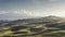 Landscape in Tuscany with farmhouse and rolling hills on a winter afternoon