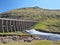 Landscape with Vestmanna rainwater harvesting dam and water spillway.