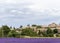 Landscape with vibrant purple Lavender field and typical village of Southern France in distance at blooming season