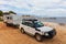 Landscape view of a 4WD and modern caravan parked next to a seaside jetty