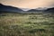 Landscape view along countryside fields towards misty Snowdonia