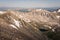 Landscape view of alpine lake surrounded by mountains from the top of Quandary Peak in Colorado.