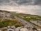 Landscape view in Burren National park, Atlantic ocean, Small road, rough terrain, dramatic sky, Part of Wild Atlantic Way