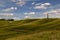 Landscape view of a chalk white horse and a 19th century monument on the hillside in Wiltshire, UK.