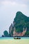 Landscape view of coastline with limestone rock and boats on ocean at Ko Phi Phi islands, Thailand. Concept of exotic tropical