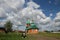 Landscape with a view of a cow in front of a rural church in Chuvashia