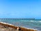 Landscape view of Dania Beach Ocean Park Pier and swimmers on the Atlantic Ocean in southern