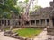 Landscape view of demolished stone architecture and aerial tree root at Preah Khan temple Angkor Wat complex, Siem Reap Cambodia.