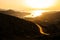 Landscape view of dramatic ocean coastline and port at sunset