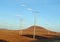 Landscape view of a empty field with electric poles