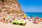 Landscape view on famous Rotonda Beach under the cliff full of sunbathing and swimming people. Popular landmark in Tropea city,
