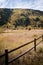 Landscape view of fence with mountains and fall foliage near Aspen, Colorado.