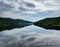 Landscape view of Glencar Lough in western Ireland with sky reflections in the calm lake water