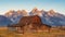 Landscape view of Grand Teton mountain range and abandoned barn, USA