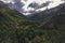 landscape with a view of a green gorge with river in mountains with a cloudy sky