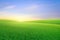 Landscape view of green grass on slope with sunrise sk