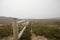 Landscape view of green grass and wooden fence in Cabo da Roca